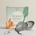 Round tea infuser with packaging on a light background