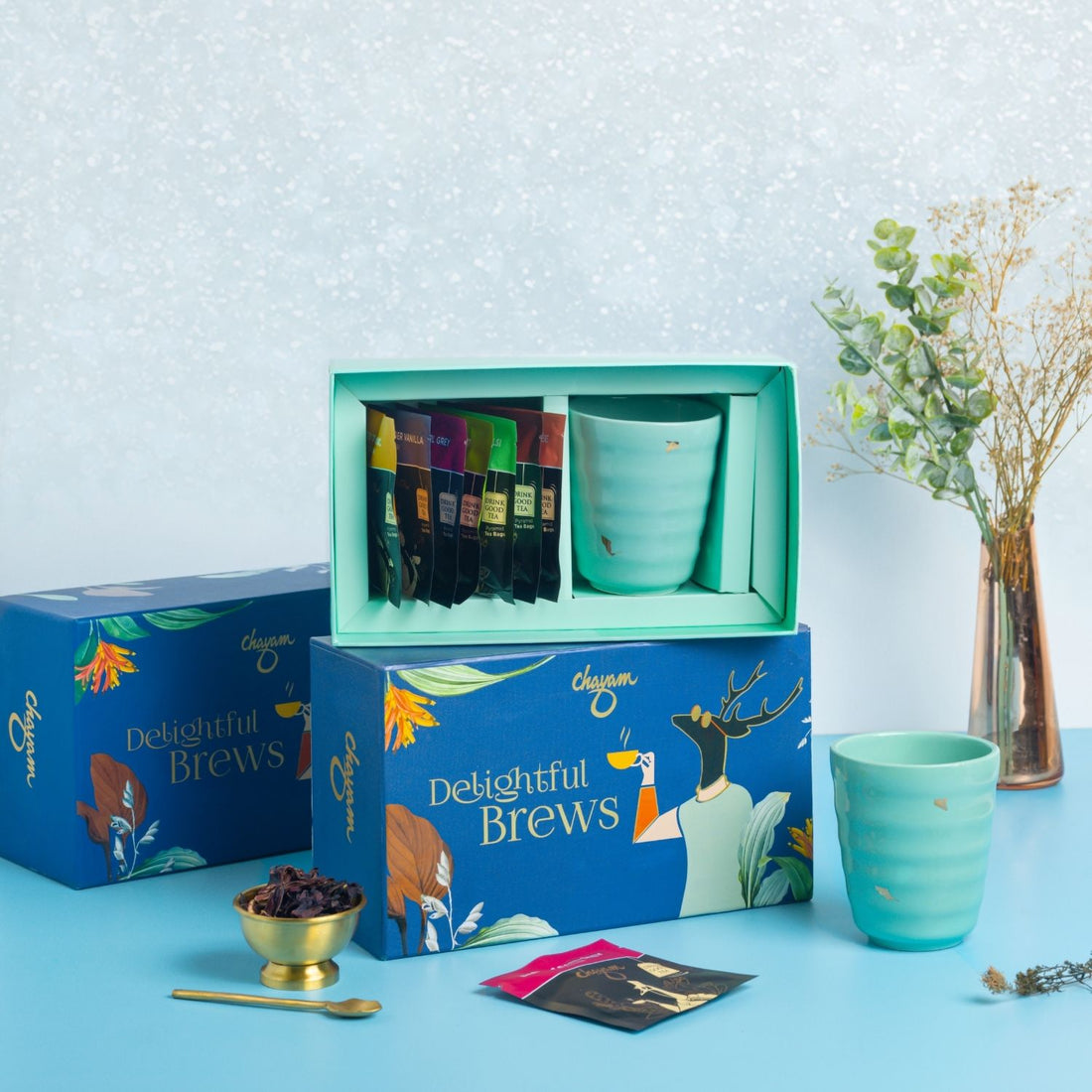 Tea set with 'Delightful Brews' packaging on a light blue background