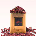 Gold container of 'Pure Hibiscus' with dried hibiscus flowers on a white background